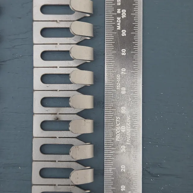 Centre Hook Stubby (32mm) hooks lined up beside a steel rule