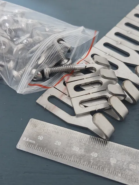 Bag of stainless screws with centre hooks and a steel rule